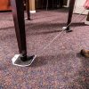 Two black plastic sleds, designed for moving heavy objects across a carpet surface.