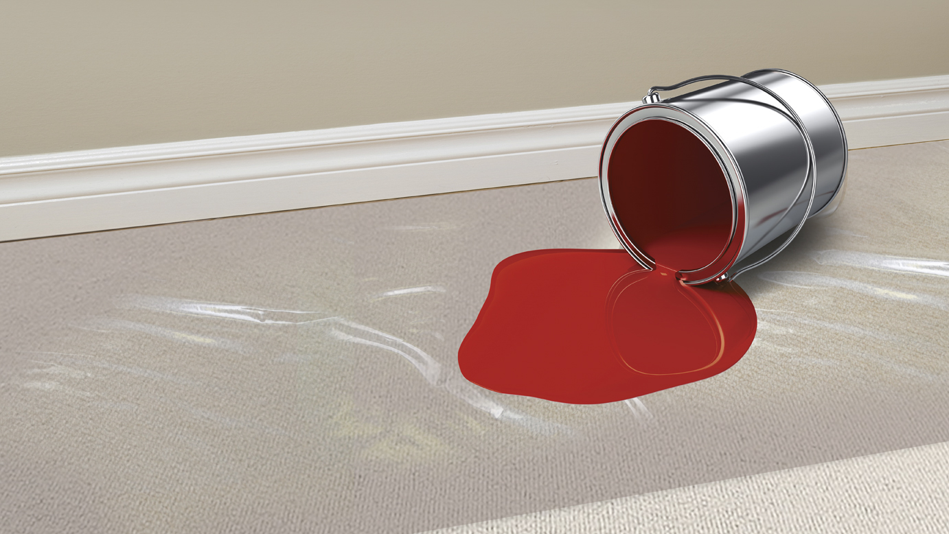 red paint spread on a protective surface for carpets.