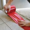 red PE tape being applied to a floor