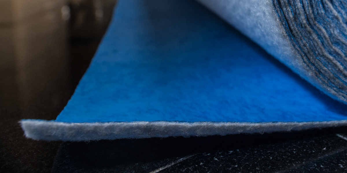 A close-up picture of a blue roll of protective material.