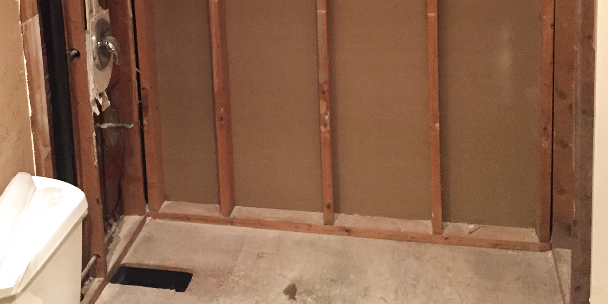 Photo of the bare walls of a bathroom being remodeled.