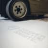 Forklift driving over white corrugated plastic floor protection sheet that has the words "Tougher than the Jobsite"