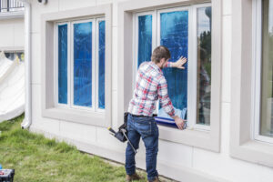 applying window shield outside home on window